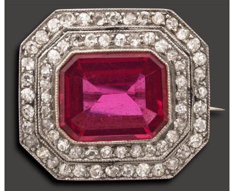 An Edwardian ruby and diamond-set broochthe rectangular cut-cornered ruby (untested but probably synthetic) collet-set above 