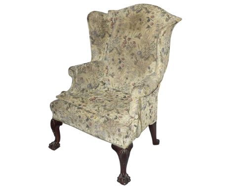 A George III &nbsp;mahogany wingback upholstered armchairpossibly Irish, the arched top with swept scrolled wings and rolled 