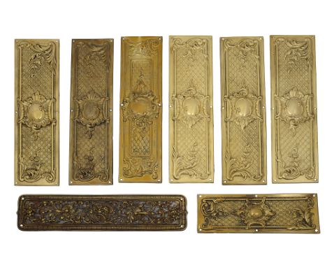 A set of seven closed trellis brass door fingers plates and two othersof which seven large and one small, three stamped RD 19