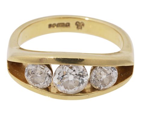 A diamond three stone ringthe graduated old brilliant-cut diamonds tension-set between the 18ct yellow gold gallery and plain