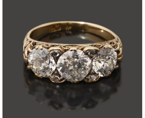 A late Victorian three stone diamond ring, the central old brilliant-cut diamonds estimated to weigh 1.20cts, each of the sim