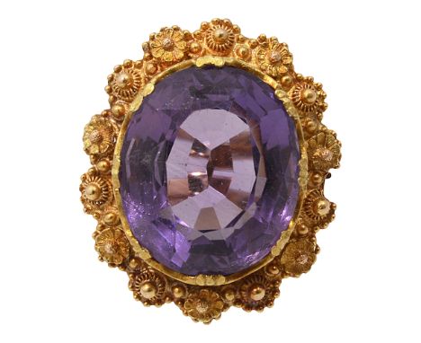 An amethyst ring, collet-set to the ornate cannetille and flowerhead surround2.2cm x 1.9cm, ring size P, 6.7gCondition: Minor