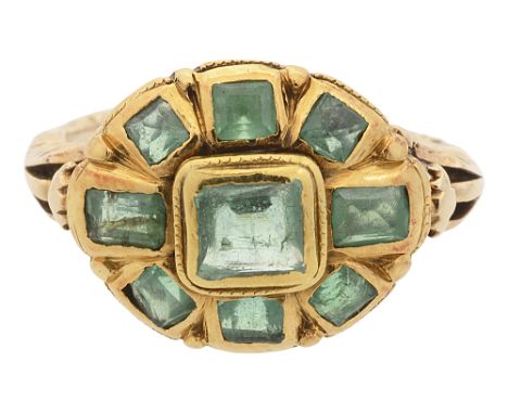 An 18th/ 19th century Spanish emerald-set ring,the oval cluster set with emeralds in yellow gold rub-over settings, ornate op