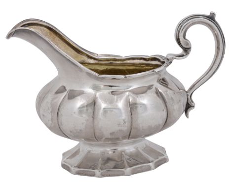 A George IV silver melon form cream jugLondon, 1827 by John Wakefieldof squat melon form with scroll handle on a spreading ba