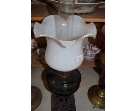 CAST METAL BASED OIL LAMP WITH GREEN GLASS FONT AND FRILLED SHADE