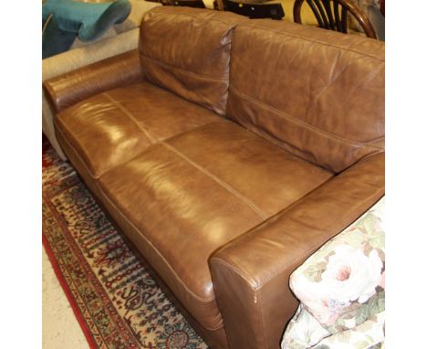 A two seat brown leather sofa and a matching foot stool   CONDITION REPORTS  Various scuffs and worn sections, some light scr