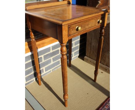 A pair of walnut side tables in the Regency manner, the burr top feather and cross-banded within a moulded edge over a frieze