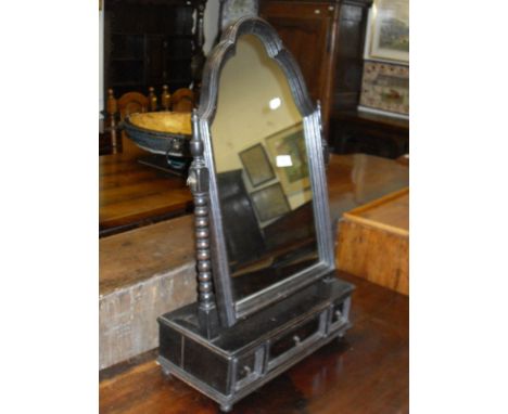 An early 20th Century oak toilet mirror in the 17th Century manner, the shaped plate on bobbin turned supports to three drawe