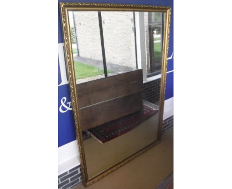 A large rectangular wall mirror in a moulded gilt effect frame   CONDITION REPORTS  Approx 195 cm x 133 cm.  Some black spott