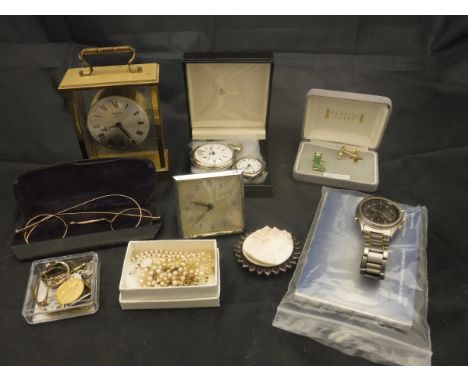 A box containing assoted watches and clocks to include a modern four glass brass carriage clock, a Sekonda titanium wrist wat