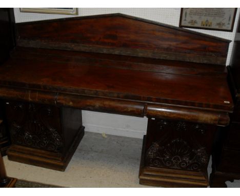 A 19th Century mahogany pedestal sideboard with architectural form back board with three drawers to the top on two plinths wi