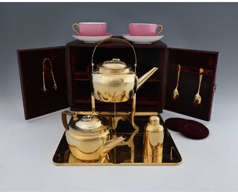 Dr Christopher Dresser for Hukin and Heath, a late Victorian silver-gilt stacking travelling tea set for two, with fitted cas