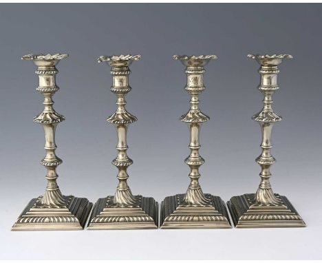 Four eighteenth-century Paktong candlesticks, each with a stepped square base, decorated with gadrooning, two with script ini