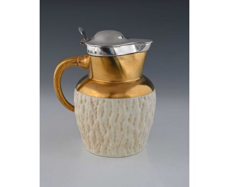 Hukin and Heath and Coalport, a silver-mounted ceramic jug in cream and gold with boar's tusk-shaped handle, Birmingham 1895,