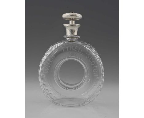 Hukin and Heath, an Edwardian silver-mounted novelty glass decanter, formed as a tyre and with silver steering wheel stopper,