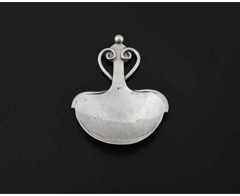 A. E. Jones, a George V Arts and Crafts silver caddy spoon, Birmingham 1919, the spread heart-shaped bowl with spot-hammered 