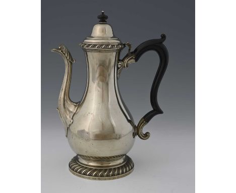 An eighteenth-century Paktong coffee pot, the body wide-bellied, with fluted spout capped with a stylised leaf, the foot and 