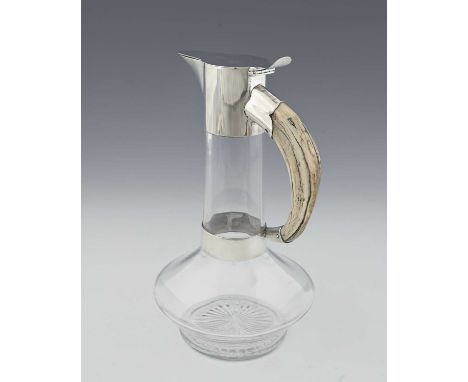 Hukin and Heath, a Victorian glass claret jug with silver mount and boar's tusk handle, the hinged flat top cover with a curv