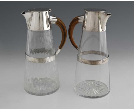 Hukin and Heath, a silver-plated and 'hammered' glass claret jug, with a wooden simulated tusk form handle, pattern number 38