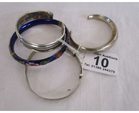 3 silver bangles together with an enamel bangle