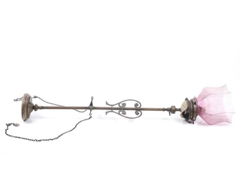 An adapted 19th century oil lamp. With ceramic shell cup below the fitting, flat pierced scrolls to the sides, on a turned wo