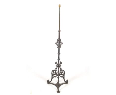 An adjustable standard lamp with a 19th century cast iron base. Photographed  height 150cm.  Condition Report: the telescopic