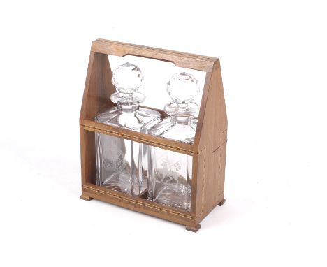Unusal Tantalus : A two bottle walnut tantalus inlaid with ebony, mahogany and holly. H29.5cm.According to written note attac