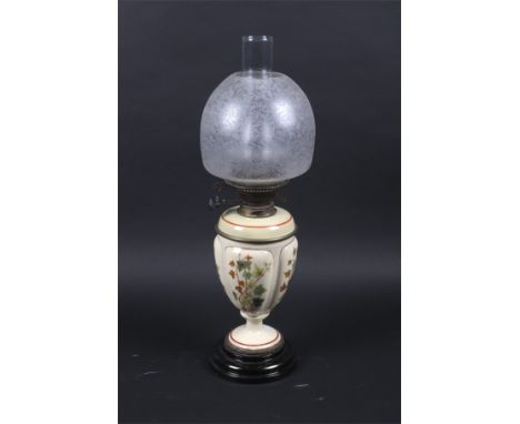 A 19th century Duplex oil lamp with Messenger's No.2 patent twin burners. On an ivy decorated ceramic pedestal base. H60cm  