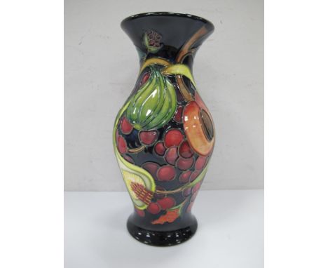 A Moorcroft Vase, with blue ground decorated with fruit, with green mark on base, Moorcroft (L) 2000 KDH 20cm high.