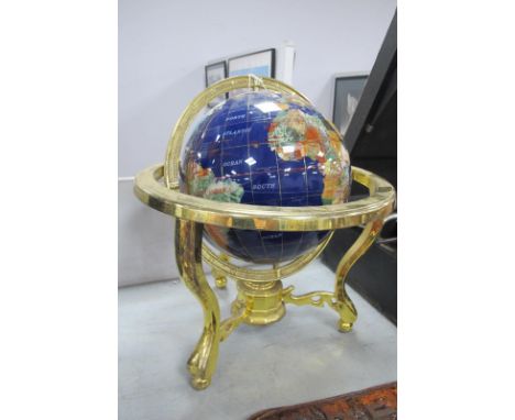 A Terrestrial Mineral Globe, in brass stand united by stretchers, with compass to centre, approximately 34cm high. 