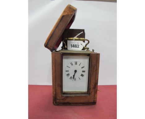 A Brass Carriage Clock, with black Roman numerals to white enamel dial, with key and carry case, 11.5cm with handle down.