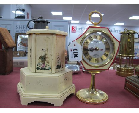 Rhythm 2 Jewels Alarm Clock, in red plastic frame, on gilt stand, 23cm high. Selcol hexagonal cigarette dispenser (needs atte