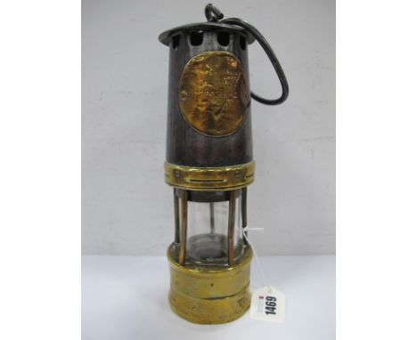 A Miners Lamp, worn brass name plate, No 1969, in need of attention 24cm.