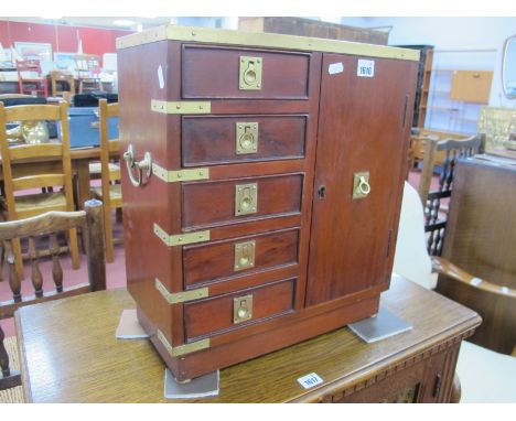 A Hardwood Campaign Chest, with scriver top, ring pull handles to five drawers and cupboard door, 40cm wide, excluding side h