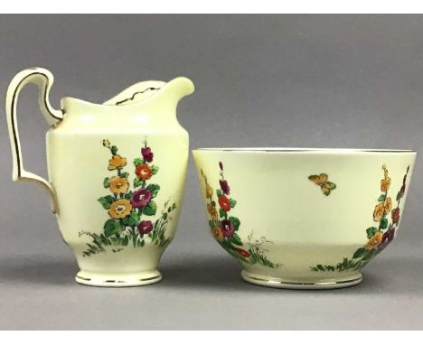 CROWN STAFFORDSHIRE HOLLYHOCK TEA SERVICE,painted with flowers in coloured enamels on a cream ground, comprising thirteen cup