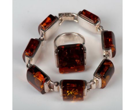 The bracelet has sterling silver and amber links with a fold-over clasp stamped 925. It measures 7"L clasp to clasp. The ring