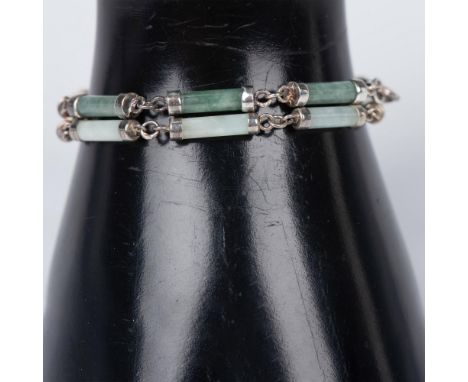 These lovely bracelets have two different shades of jade which compliment each other beautifully . The barrel shapes are capp