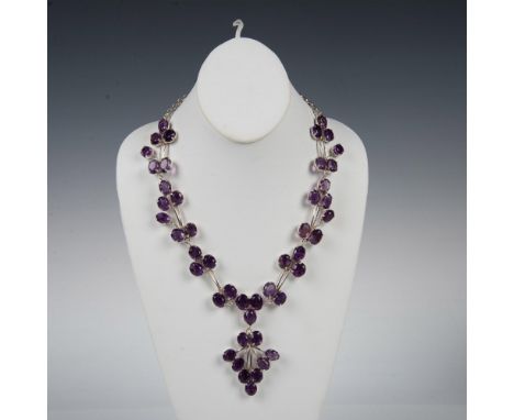 Stunning necklace sparkling with 46 amethyst stones set in sterling silver with a hook clasp. It measures 21.5"L end to end a