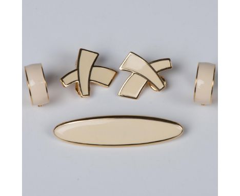 Timeless pieces. Sleek bar brooch in a creamy white with rounded gold tone edges. Can be worn in either direction. X shape cr