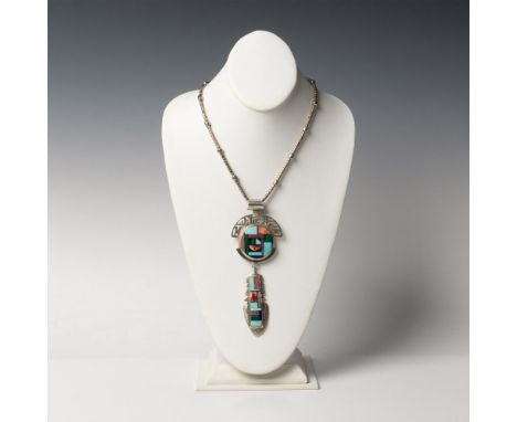 The large Southwestern tribal pendant with a hanging feather measures 5.75"L x 2.25"W. It has inlaid spiny oyster shell, mala