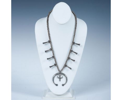 Unsigned sterling silver squash blossom necklace with 8 blossoms and large stylized central pendant. Tested sterling silver. 