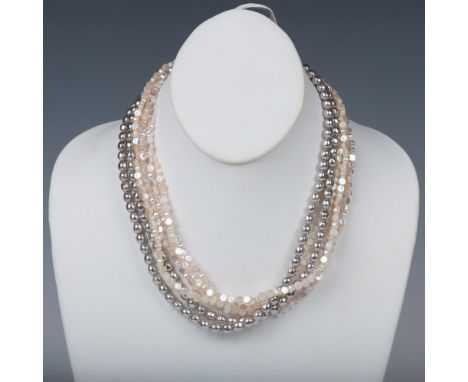 Four strands of flat round white pearlescent beads with two strands of faux silver pearls. Dimensions: 18"LManufacturer: Mone