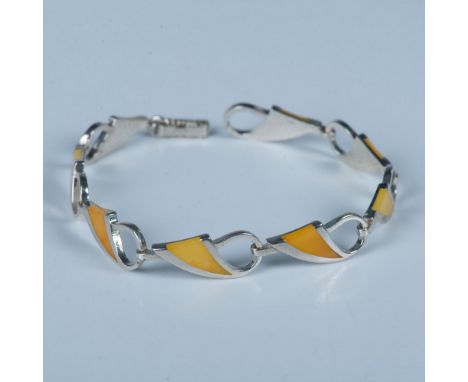 Sterling silver wave pattern links inlaid with yellow Baltic amber. The bracelet has a fold-over clasp stamped 925 and it mea
