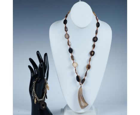 This unique large polished horn pendant is truly amazing. The necklace itself is slices of horn strung with free form shell a