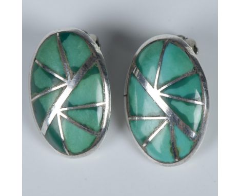 Beautiful handmade Native American clip-on earrings featuring sterling silver inlaid with turquoise stones. Stamped K.E.K. on