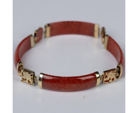 This charming bracelet with rich red jade is sure to bring you good luck. Between each section of jade is a jade square with 