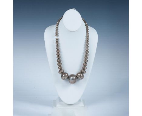 This chunky handmade Native American necklace has beads with an engraved tribal pattern. Unmarked but tested sterling silver.
