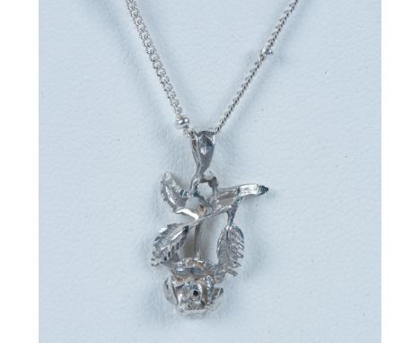 This necklace has a finely detailed flower on a fancy bead station chain stamped 925 on the spring ring clasp. 6g. Dimensions