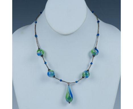 This necklace is made from sterling silver and hollow glass beads accented with small blue beads. It has a lobster clasp stam