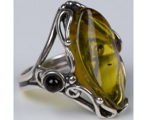 Scrolling sterling silver wraps beautifully around the large yellow green oval center stone. Adorning either side set low are